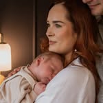 Baby sleep consultant with babu in her arms.